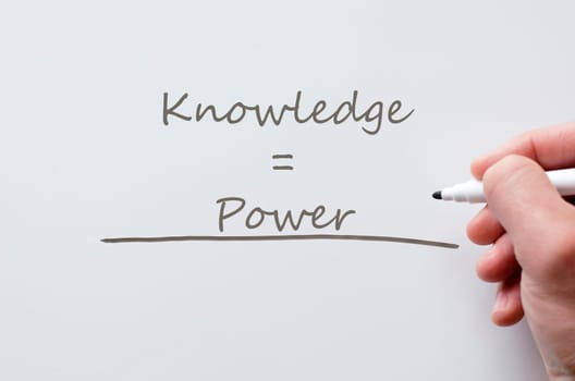 Human hand writing knowledge and power on whiteboard