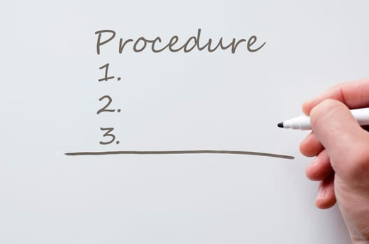 Human hand writing procedure on whiteboard