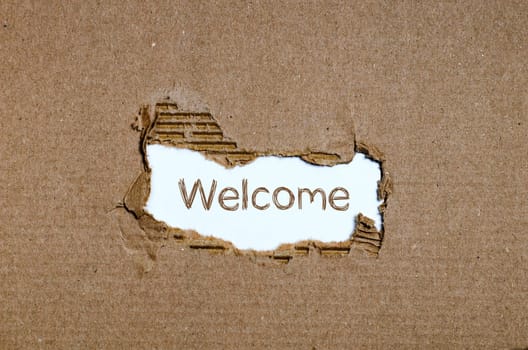 The word welcome appearing behind torn paper.