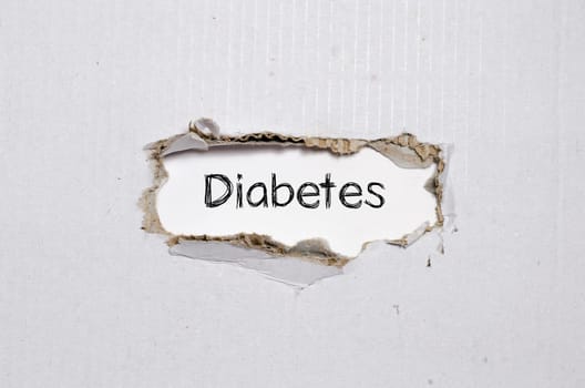 The word diabetes appearing behind torn paper.