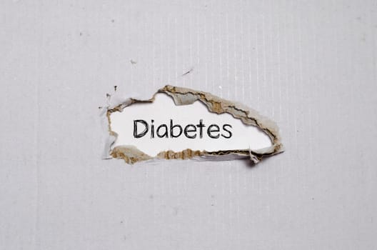 The word diabetes appearing behind torn paper.