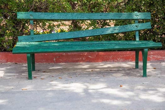Badly fixed bench made with gree wood panels