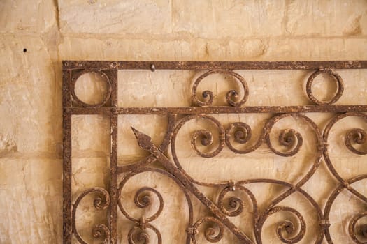 Old iron decoration over an ancient wall