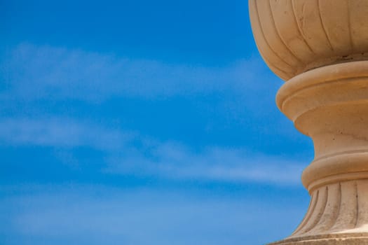 An ancient vase over a blue spring sky
