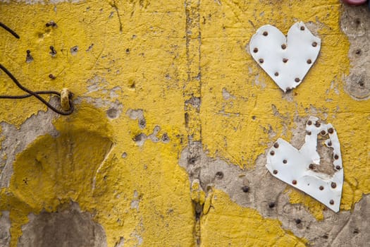 Hand painted yellow wall with plastic made hearts