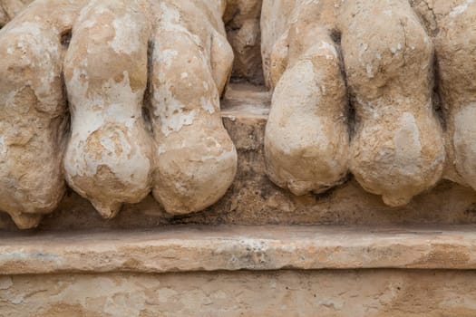 Rocky and ancient lion feet damaged by the weather