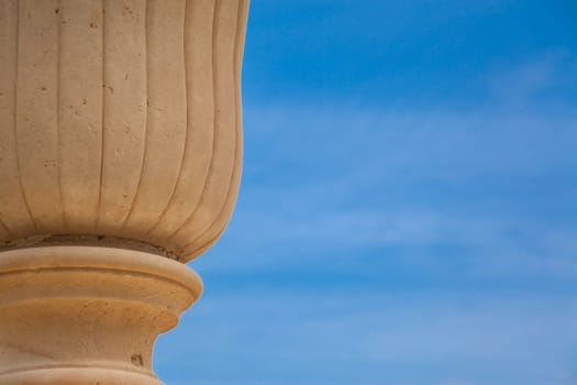 An ancient vase over a blue spring sky