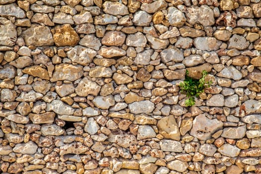 Handmade wall with small different colured stones