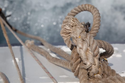 Rope knotted on itself with waves on a boat