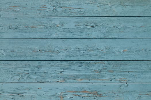 A weathered wall made with cyan painted wood panels