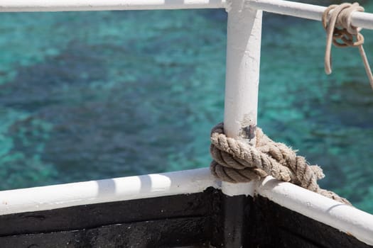 Knotted weathered boat rope on a blue sea