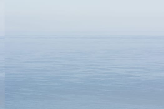 Ocean background with clouds and fog at the horizon