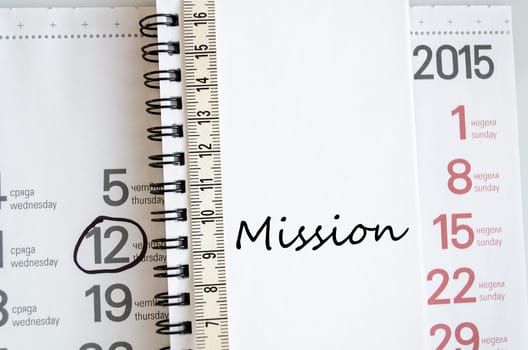 Mission text concept over tape measure and calendar background..