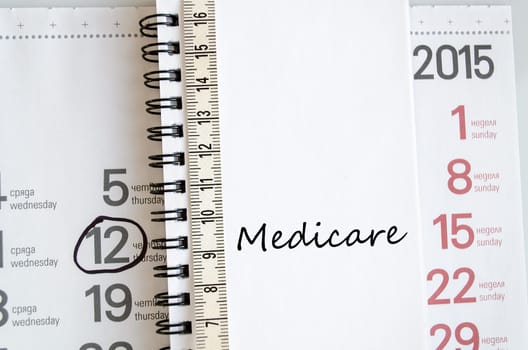 Medicare text concept over tape measure and calendar background..
