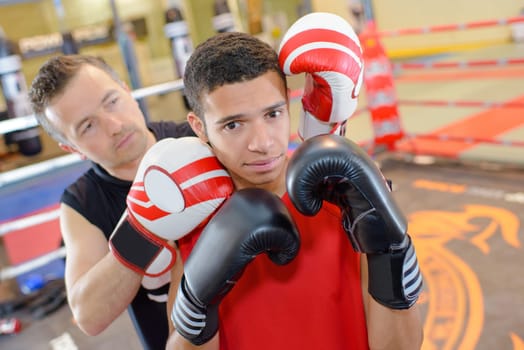Young man with boxing instructor