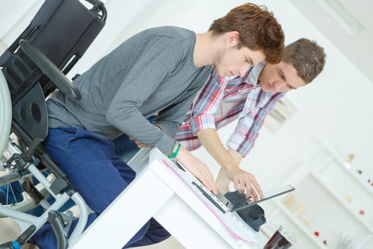 Two male teenagers studying at home