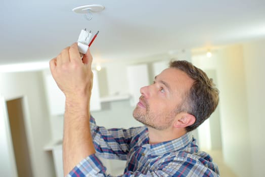 Attaching a smoke alarm to the ceiling