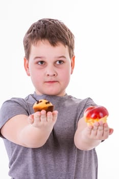 little boy with food isolated on white background - apple or a muffin