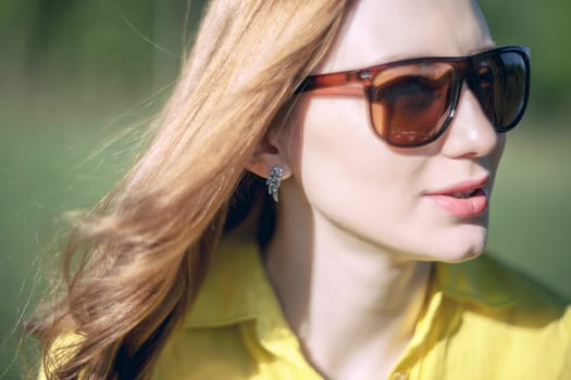 girl, beautiful, young, blonde, big sunglasses in close-up, outdoor summer, looking through his glasses, the distance