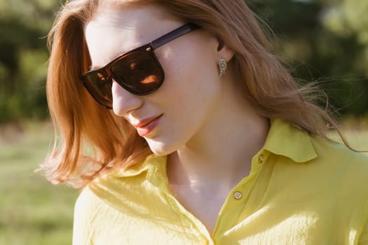 girl, beautiful, young, blonde, big sunglasses in close-up, outdoor summer, looking through his glasses, the distance