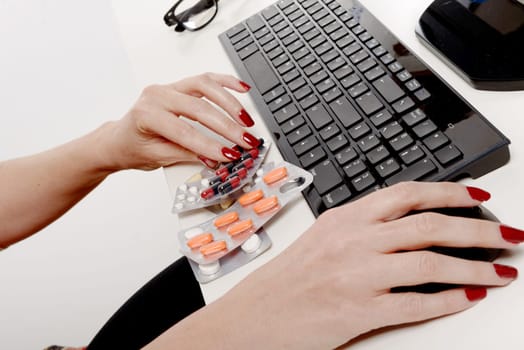 a businesswoman taking pills at workplace