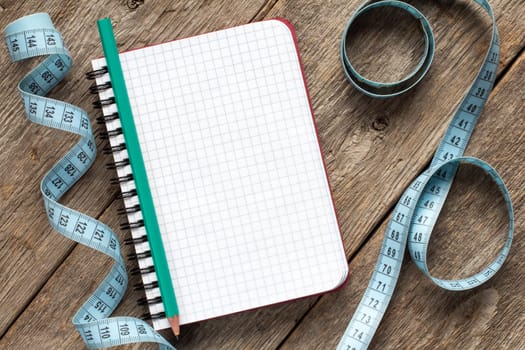 Measure tape,pencil and blank notebook for your resolutions