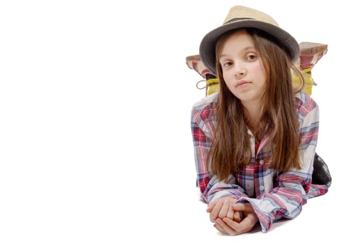 preteen girl in hipster style, lying on the floor, isolated on white background
