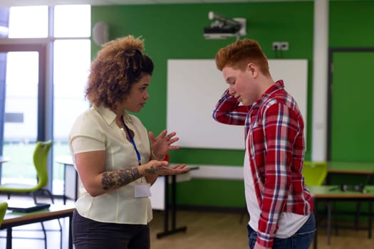 Teenage student being told off by his teacher at school.