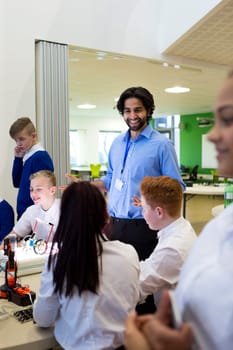 Technology teacher talking to his students during a lesson.