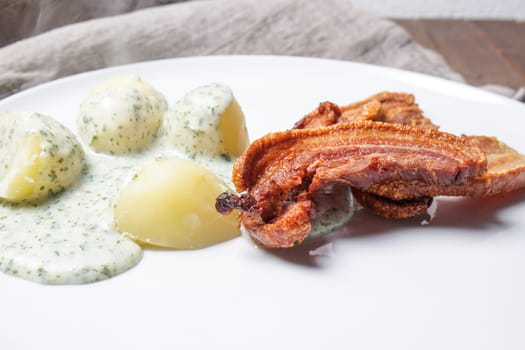 Denmark&#39 s national dish fried pork belly with parsley sauce and potatoes