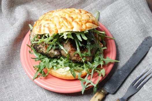Hamburger for dinner, with lettuce and cheese bun