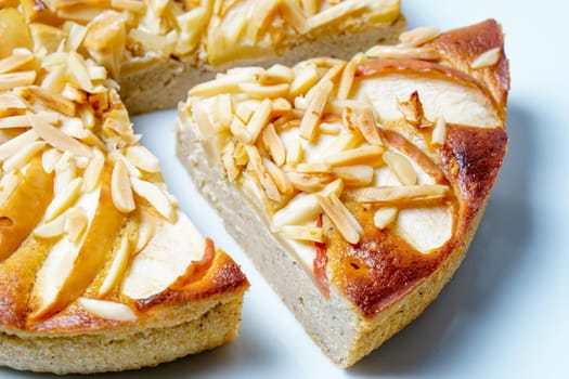 Apple pie with almonds served on a white plate