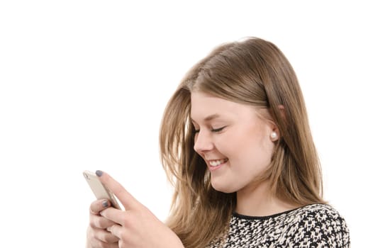 Happy female teenager writing on a mobile phone