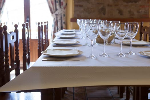 Tables ready and waiting for the guests to arrive at a rustic restaurant