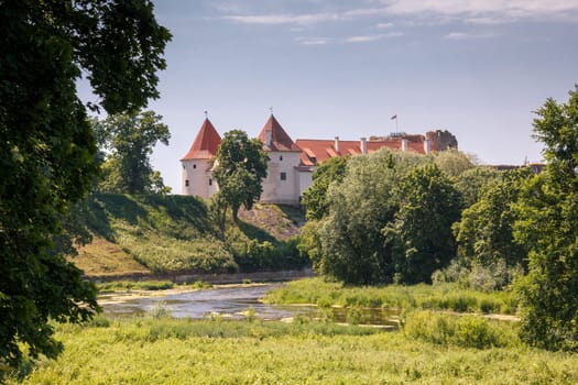 An old Bauskas castle in Latvia in rural surroundings