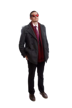 A male wearing formal dress with red sunglasses looking up