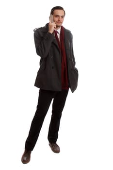 A formal businessman standing and talking on his phone