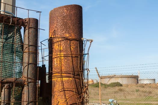 Rusted wire netting in industrial place. Particular of a pylon