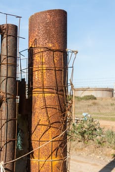 Rusted wire netting in industrial place. Particular of a pylon