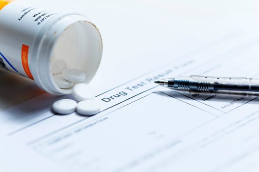 Syringe with glass vials and medications pills drug on white