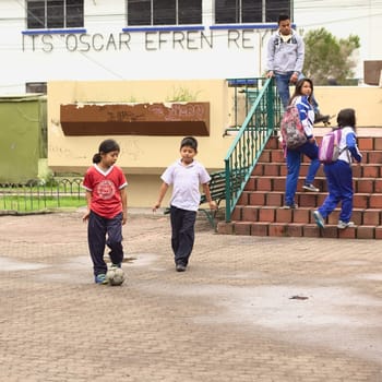 BANOS, ECUADOR - FEBRUARY 25, 2014: Unidentified children playing football in Sebastian Acosta Park on February 25, 2014 in Banos, Ecuador.