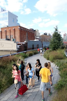 NEW YORK CITY - SEPTEMBER 03: People at High Line Park in NYC on September 03th, 2013. The High Line is a public park built on an historic freight rail line elevated above the streets on Manhattan West Side.