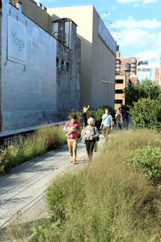 NEW YORK CITY - SEPTEMBER 03: People at High Line Park in NYC on September 03th, 2013. The High Line is a public park built on an historic freight rail line elevated above the streets on Manhattan West Side.