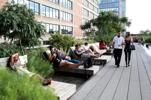NEW YORK CITY - SEPTEMBER 03: People at High Line Park in NYC on September 03th, 2013. The High Line is a public park built on an historic freight rail line elevated above the streets on Manhattan West Side.
