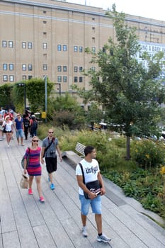 NEW YORK CITY - SEPTEMBER 03: People at High Line Park in NYC on September 03th, 2013. The High Line is a public park built on an historic freight rail line elevated above the streets on Manhattan West Side.