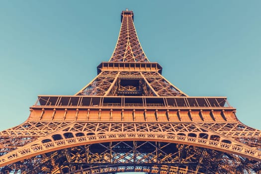 The Eiffel Tower, located on the Champ de Mars in Paris, France, selective focus, vintage effect