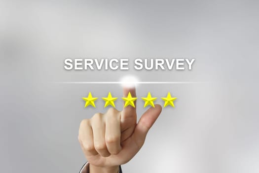 business hand clicking service survey with five stars on screen