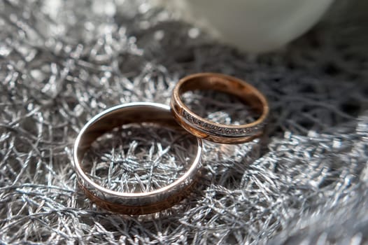 Wedding rings in white gold, white clay saucer with the word always have to be your friend