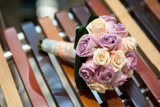 Beautiful wedding bridal bouquet lying on a tree stump made of cotton and blue colors, winter