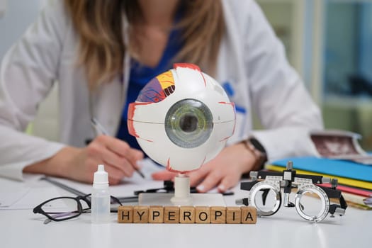 An optometrist thoroughly studies hyperopia by utilizing various models and tools in a clinical practice setting